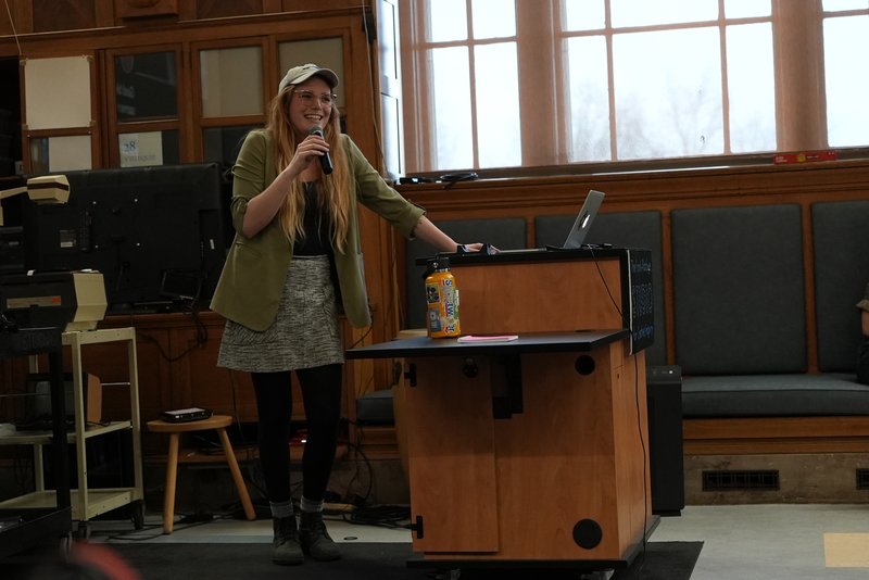 Lorelei d'Andriole speaking with a microphone at the STUDIO